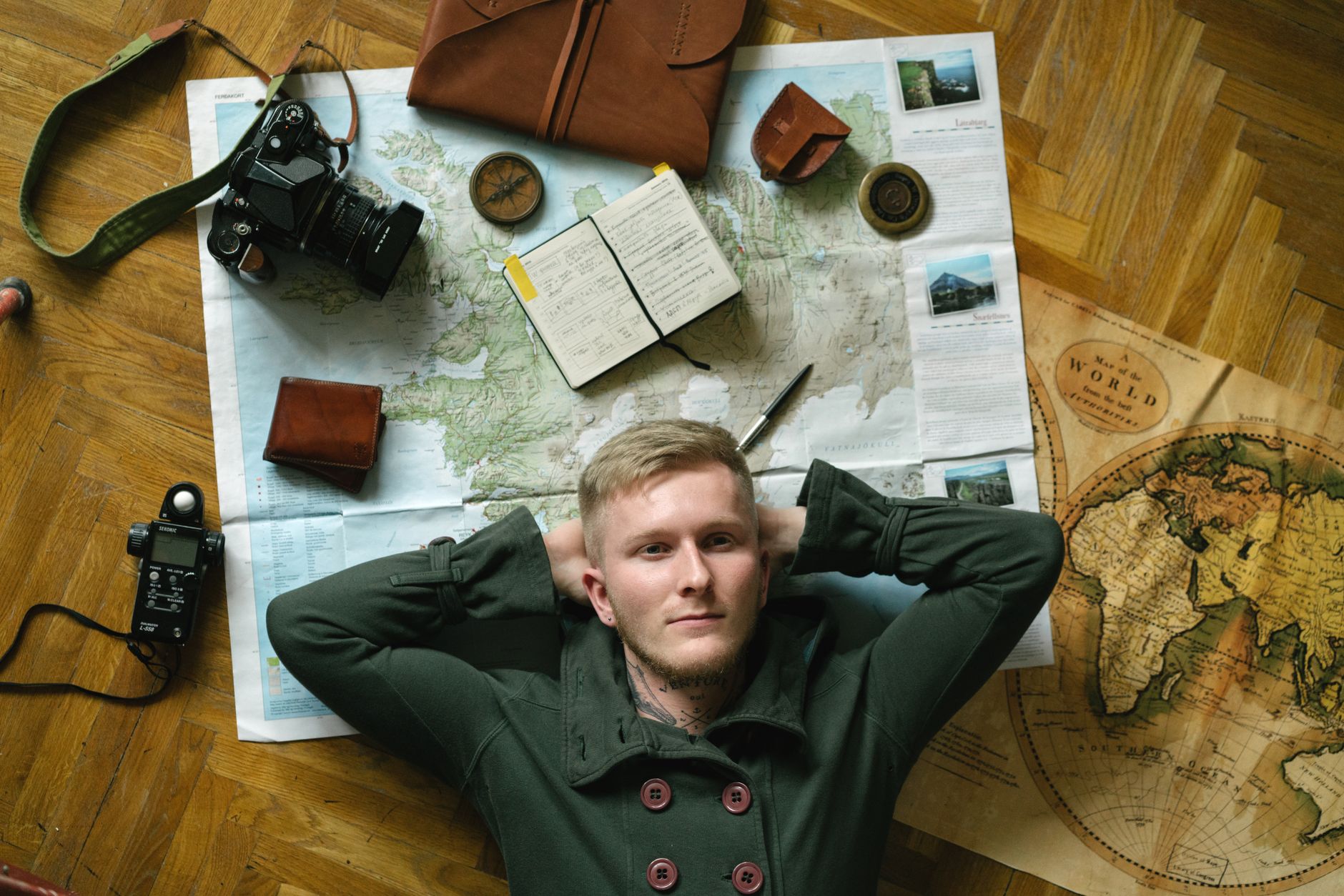 Travel writer examining maps in quiet studio